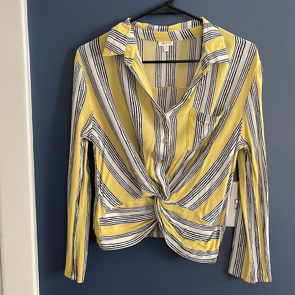 Yellow blouse with black and white stripes
